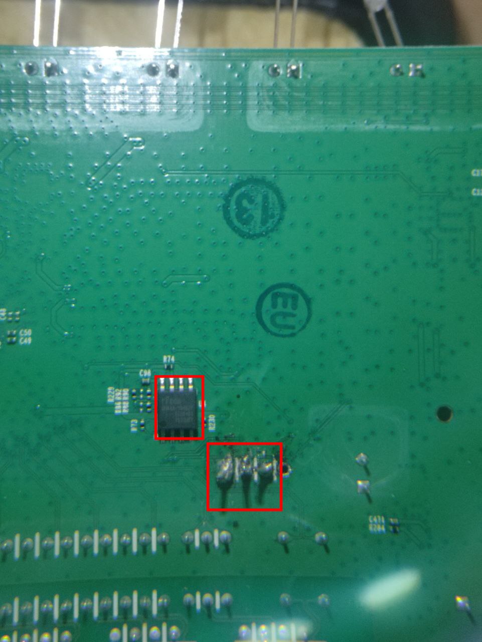 Underside of the router PCB, red boxes on the eight-pin SOIC SPI flash chip labelled U4 (top) and the three wires soldered to the serial header pads (bottom)